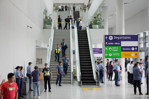 Security officers patrol the airport after former President Rodrigo Duterte was arrested, in Manila, Philippines, Tuesday, March 11, 2025. (AP Photo/Aaron Favila)