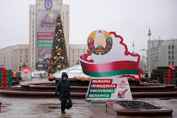 A woman walks past election billboards ahead of presidential elections in Minsk, Belarus, Friday, Jan. 24, 2025. (AP Photo/Pavel Bednyakov)