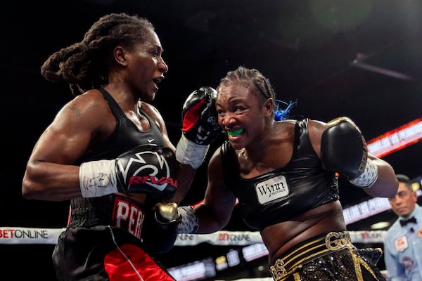 Claressa Shields, right, exchanges punches with Danielle Perkins during the undisputed heavyweight title match on Sunday, Feb. 2, 2025 at Dort Financial Center in Flint. (Jake May/The Flint Journal via AP)