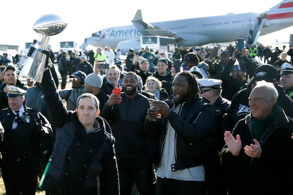 FILE - Philadelphia Eagles general manager Howie Roseman holds up the Vince Lombardi Trophy while displaying it to fans gathered to welcome them in Philadelphia, Feb. 5, 2018, a day after defeating the New England Patriots in the NFL footbal Super Bowl 52 game. (AP Photo/Julio Cortez, File0