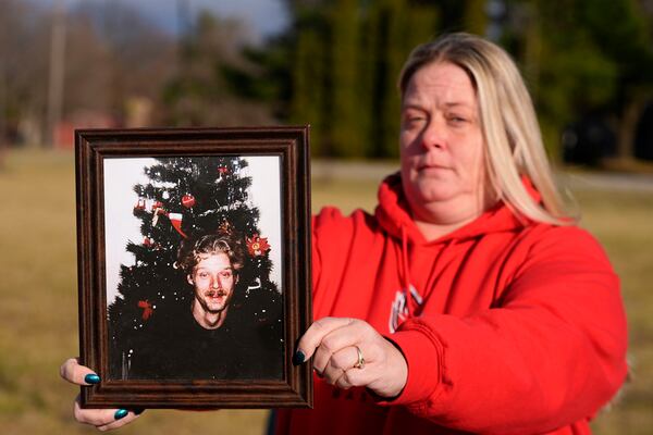 Shannon Doughty holds a photo of her late brother Allen Livingston, who was identified in October 2023 as the ninth known victim of suspected serial killer Herbert Baumeister, Saturday, Dec. 21, 2024, in Westfield, Ind. (AP Photo/Darron Cummings)