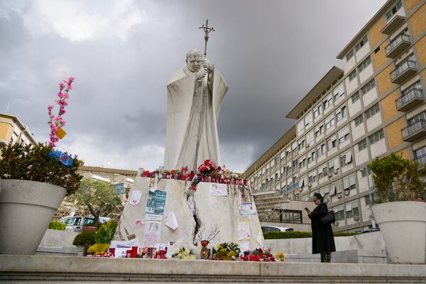 People pray for Pope Francis in front of the Agostino Gemelli Polyclinic, in Rome, Thursday, March 13, 2025, where the Pontiff is hospitalized since Friday, Feb. 14. (AP Photo/Andrew Medichini)