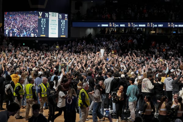 Vanderbilt fans storm the court after the team's win in an NCAA college basketball game against Tennessee, Saturday, Jan. 18, 2025, in Nashville, Tenn. (AP Photo/George Walker IV)