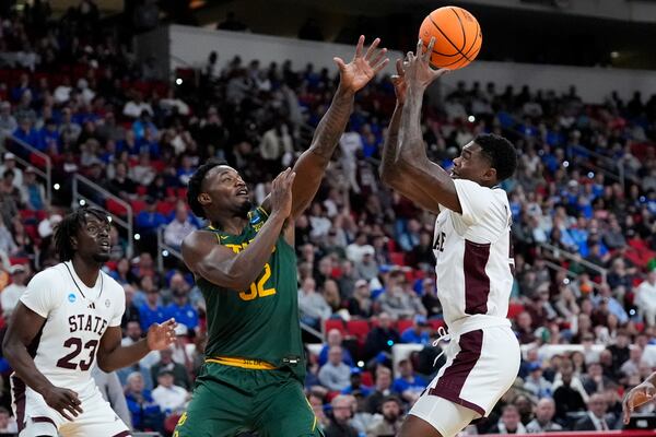 Baylor guard Jalen Celestine (32) and Mississippi State guard Shawn Jones Jr. (5) battle for control of the ball during the first half in the first round of the NCAA college basketball tournament, Friday, March 21, 2025, in Raleigh, N.C. (AP Photo/Stephanie Scarbrough)