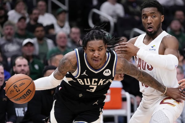 Milwaukee Bucks' Kevin Porter Jr. gets by Cleveland Cavaliers' Donovan Mitchell during the first half of an NBA basketball game Sunday, Mar. 9, 2025, in Milwaukee. (AP Photo/Morry Gash)