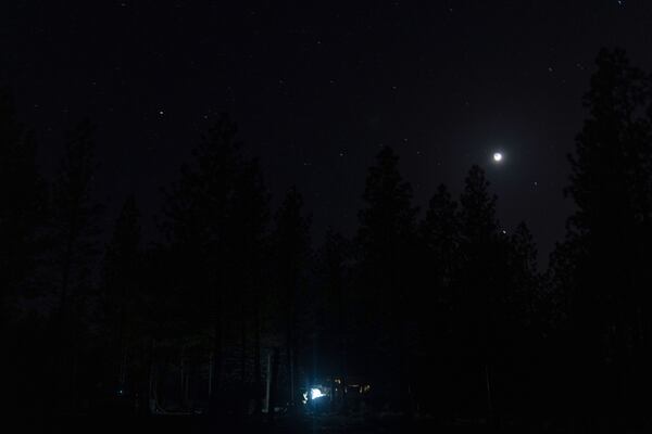 Greg Bishop works to get an RV to start at a homeless encampment in Deschutes National Forest, Wednesday, April 30, 2025 near Bend, Ore. (AP Photo/Jenny Kane)