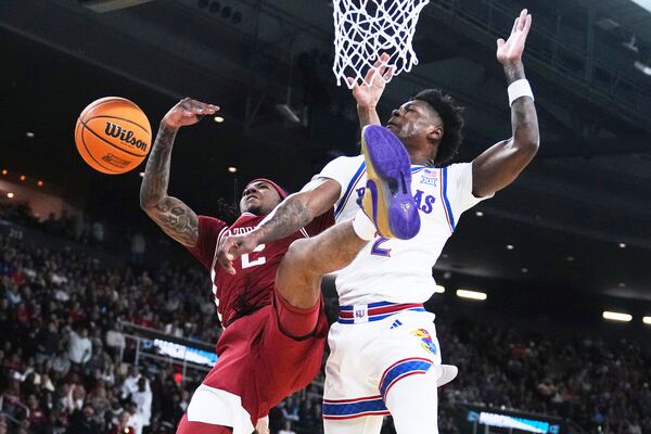 Arkansas guard Boogie Fland, left, is fouled by Kansas guard AJ Storr, right, during the first half in the first round of the NCAA college basketball tournament, Thursday, March 20, 2025, in Providence, R.I. (AP Photo/Charles Krupa)