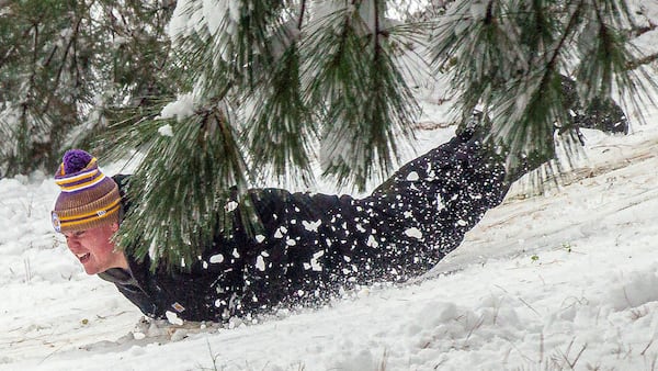 Drew McDonald slides down a hill as snow falls Friday, Jan. 10, 2025, in East Florence, Ala. (Dan Busey/The TimesDaily via AP)