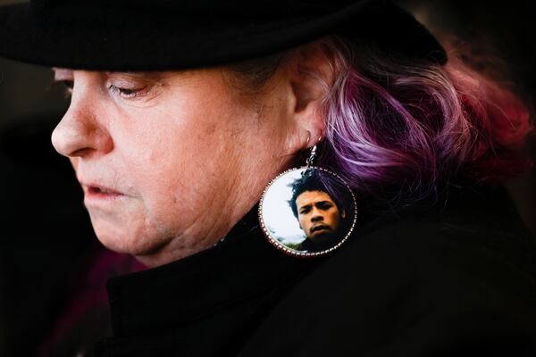 Elaine Simons wears earrings with a photo of her foster son, Jesse Sarey, at the sentencing of Jeffrey Nelson, an Auburn police officer convicted of murder for fatally shooting Sarey in 2019, at the King County Maleng Regional Justice Center in Kent, Wash., Thursday, Jan. 23, 2025. (Karen Ducey/The Seattle Times via AP)