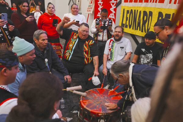 In this image provided by the NDN Collective, Leonard Peltier, bottom right, a Native American activist released from a Florida prison where he had been serving a life sentence in the 1975 killings of two FBI agents, participates in a celebration during a welcome event, Wednesday, Feb. 19, 2025, at the Sky Dancer Casino Resort near Belcourt, N.D., on the Turtle Mountain Reservation (Angel White Eyes/NDN Collective via AP)