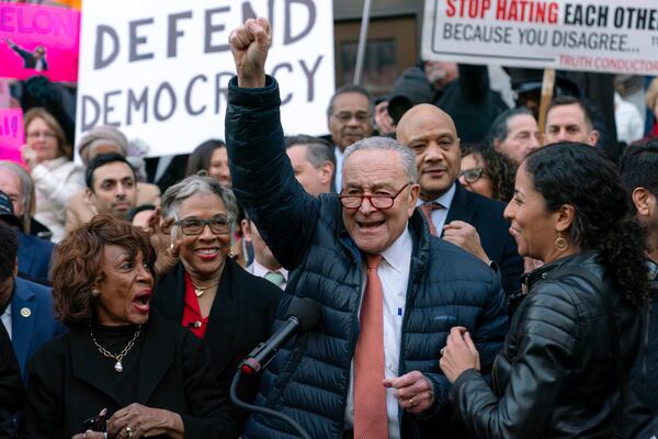 Senate Minority Leader Chuck Schumer, D-N.Y., accompanied by other members of congress, speaks during a rally against Elon Musk outside the Treasury Department in Washington, Tuesday, Jan. 30, 2025. (AP Photo/Jose Luis Magana)