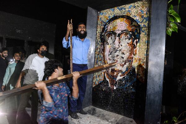 Protesters vandalize a portrait of Sheikh Mujibur Rahman, Bangladesh's former leader and the father of the country's ousted Prime Minister Sheikh Hasina, at his residence at Dhanmondi, in Dhaka in Dhaka, Bangladesh, Wednesday, Feb. 5, 2025. (AP Photo/Mahmud Hossain Opu)