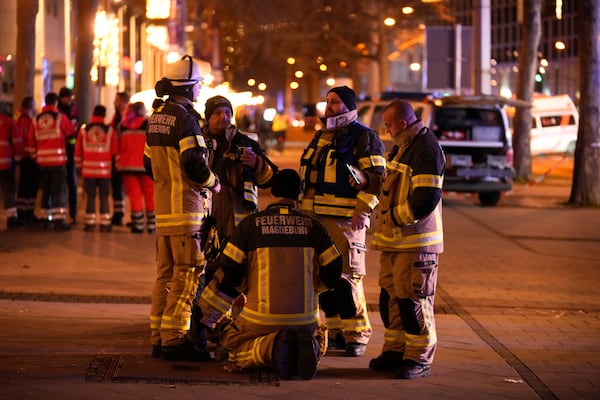 Emergency services work in a cordoned-off area near a Christmas Market, after a car drove into a crowd in Magdeburg, Germany, Friday, Dec. 20, 2024. (AP Photo/Ebrahim Noroozi)