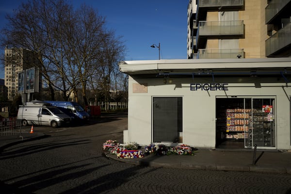 Wreaths lie in front of the Hypercacher Supermarket after commemorations marking 10 years since an Islamist attack on the Charlie Hebdo satirical newspaper and the Hypercacher jewish supermarket, in Paris Tuesday Jan. 7, 2025. (AP Photo/Thibault Camus)