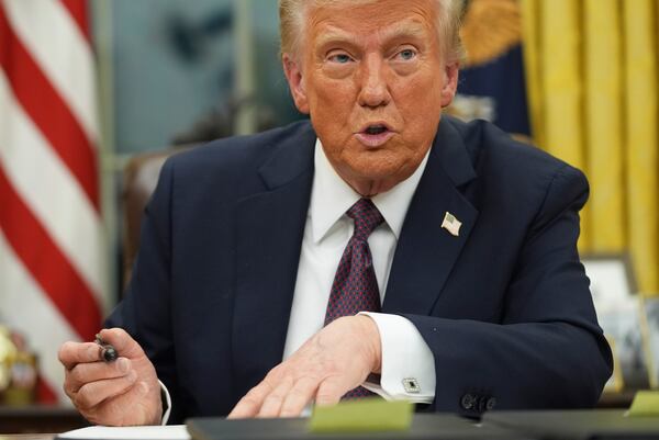 President Donald Trump talks as he signs executive orders in the Oval Office of the White House, Monday, Jan. 20, 2025, in Washington. (AP Photo/Evan Vucci)