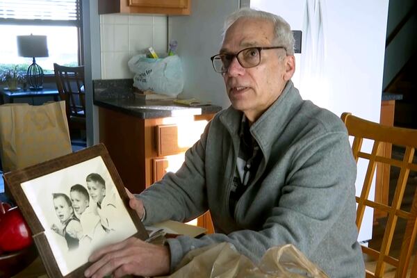 John Prevost, brother of new Pope Leo XIV, holds a portrait of the three Prevost brothers from 1958, Pope Leo, 3, left, John, 4, and Louis, 7, at his home Thursday, May 8, 2025, in New Lenox, Ill. (AP Photo/Obed Lamy)
