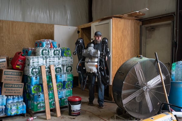 Russell Hedrick takes a DJI drone out of the closet to put crop cover on his farm, Tuesday, Dec. 17, 2024, in Hickory, N.C. (AP Photo/Allison Joyce)