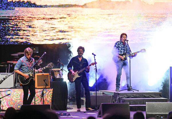 Musician John Fogerty, right, performs with his sons Shane Fogerty, far left, and Tyler Fogerty during his 80th birthday celebration concert at the Beacon Theatre on Thursday, May 29, 2025, in New York. (Photo by Evan Agostini/Invision/AP)