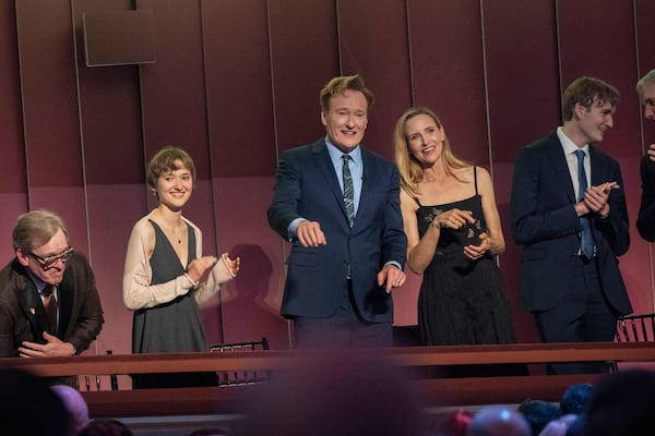 Comedian Conan O'Brien, center, and his wife, Liza Powel O'Brien, looks out on the crowd at the start of the 25th Annual Mark Twain Prize for American Humor Celebrating Conan O'Brien, Sunday, March 23, 2025, at the Kennedy Center for the Performing Arts in Washington. (AP Photo/Kevin Wolf)