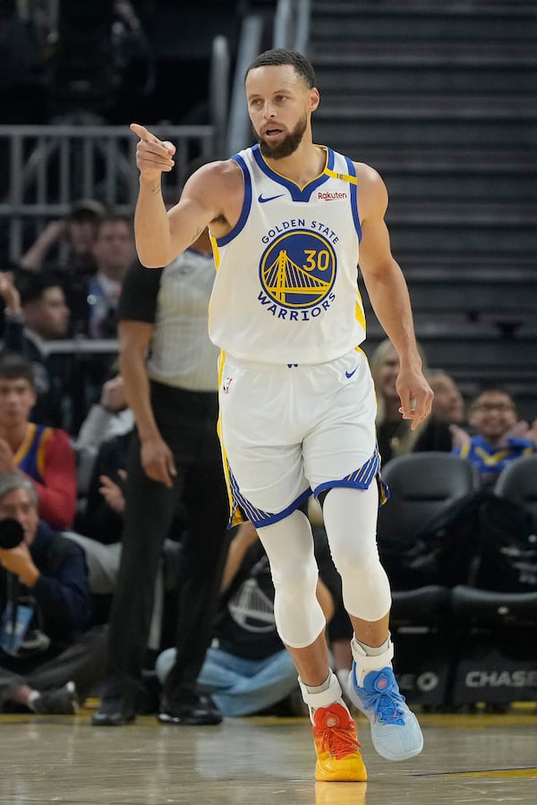 Golden State Warriors guard Stephen Curry (30) gestures after making a 3-point basket during the first half of an NBA basketball game against the Detroit Pistons in San Francisco, Saturday, March 8, 2025. (AP Photo/Jeff Chiu)