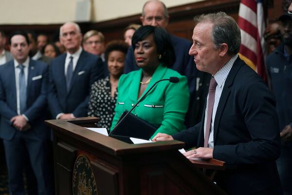 Philadelphia 76ers owner Josh Harris, right, speaks during a news conference in Philadelphia, Monday, Jan. 13, 2025, announcing that the 76ers will partner with Comcast, their current landlord, to build a new arena in South Philadelphia and abandon a deal with the city to build the arena downtown,. (AP Photo/Matt Rourke)