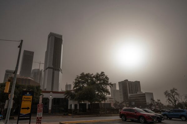 Dust from West Texas brought in by high winds obscures the sun over downtown Austin, Tuesday, March 4, 2025. (Mikala Compton/Austin American-Statesman via AP)