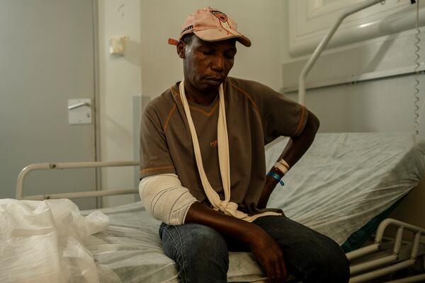 Saindou Mohamadi, father of 6, sits on his bed at the Mayotte Central Hospital after being injured while attempting to reach his home in Mamoudzou, Mayotte, Tuesday, Dec. 20, 2024. (AP Photo/Adrienne Surprenant)