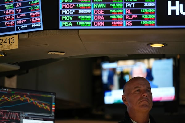 People work on the floor at the New York Stock Exchange in New York, Monday, Feb. 24, 2025. (AP Photo/Seth Wenig)