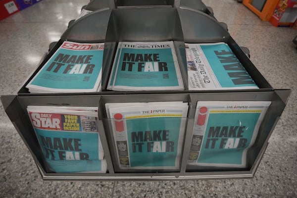 British newspapers are wrapped as a protest against the British government's planned changes to the law around artificial intelligence that would allow AI models to be more easily trained on copyrighted material, in London, Tuesday, Feb. 25, 2025. (AP Photo/Kin Cheung)