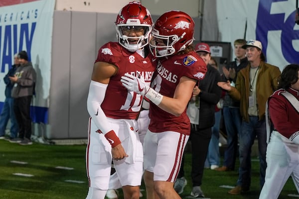 Arkansas quarterback Taylen Green, left, celebrates his touchdown with wide receiver Isaac TeSlaa, right, during the first half of the Liberty Bowl NCAA college football game against Texas Tech, Friday, Dec. 27, 2024, in Memphis, Tenn. (AP Photo/George Walker IV)