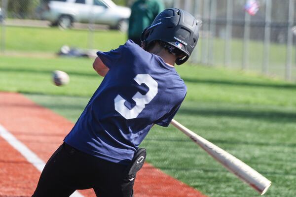 Youth ballplayer Josiah Jones bats during youth baseball game in Monroeville, Pa., with his sliding matt in his back pocket on April 27, 2025. (AP Photo/Gene J. Puskar)