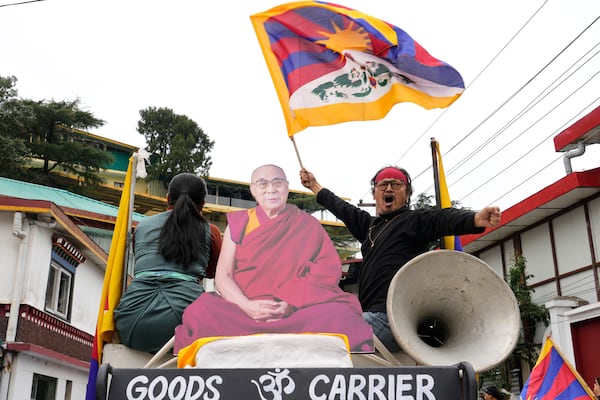 An exiled Tibetan waves the national flag as Tibetans mark the 66th anniversary of an uprising in Tibet's capital Lhasa, by participating in a march in Dharamshala, India, Monday, March 10, 2025. (AP Photo/Ashwini Bhatia)