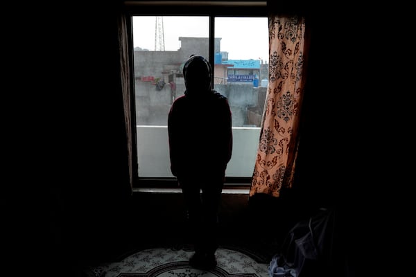 An Afghan refugee woman, who asked not to use her name and not to show her face fearing her identity could lead to her capture, poses for photographer following her interview with The Associated Press, in Islamabad, Pakistan, Wednesday, Jan. 22, 2025. (AP Photo/Anjum Naveed)