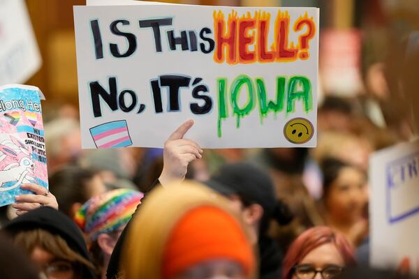 Protesters fill the Iowa state Capitol to denounce a bill that would strip the state civil rights code of protections based on gender identity, Thursday, Feb. 27, 2025, in Des Moines, Iowa. (AP Photo/Charlie Neibergall)