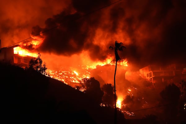 The Palisades Fire burns homes on a hilltop in the Pacific Palisades neighborhood of Los Angeles, Wednesday, Jan. 8, 2025. (AP Photo/Mark J. Terrill)