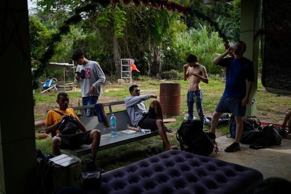 Venezuelan migrants settle in to spend the night in Puerto Carti, on Panama's Caribbean coast, Saturday, Feb. 22, 2025, where they plan to board boats to Colombia after turning back from southern Mexico where they gave up hopes of reaching the U.S. amid President Trump's crackdown on migration. (AP Photo/Matias Delacroix)