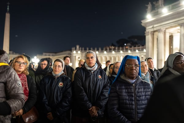 Catholic faithful attend a nightly rosary prayer for the health of Pope Francis in St. Peter's Square at the Vatican, Sunday, March 2, 2025. (AP Photo/Mosa'ab Elshamy)