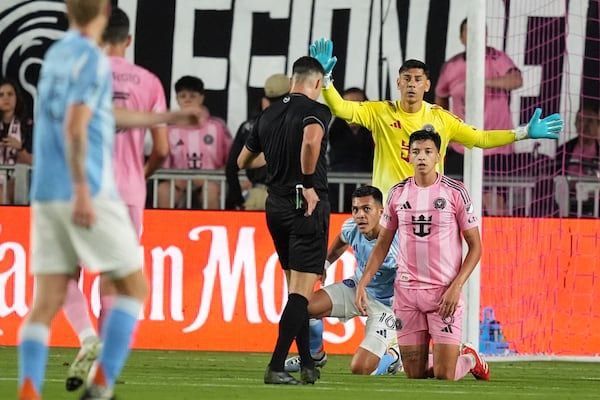 A referee pulls out a red card for Inter Miami midfielder Tomas Aviles (6) as New York City FC forward Alonso Martinez (16) and Inter Miami goalkeeper Oscar Ustari (19) look on during the first half of an MLS soccer match, Saturday, Feb. 22, 2025, in Fort Lauderdale, Fla. (AP Photo/Rebecca Blackwell)