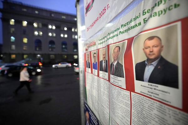 Portraits of candidates are displayed on an election poster ahead of presidential elections in Minsk, Belarus, Friday, Jan. 24, 2025. (AP Photo/Pavel Bednyakov)