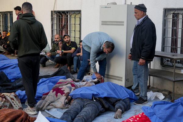 The bodies of Palestinians killed in an Israeli army airstrikes are brought to Shifa hospital in Gaza City, Tuesday, March 18, 2025. (AP Photo/Abdel Kareem Hana)