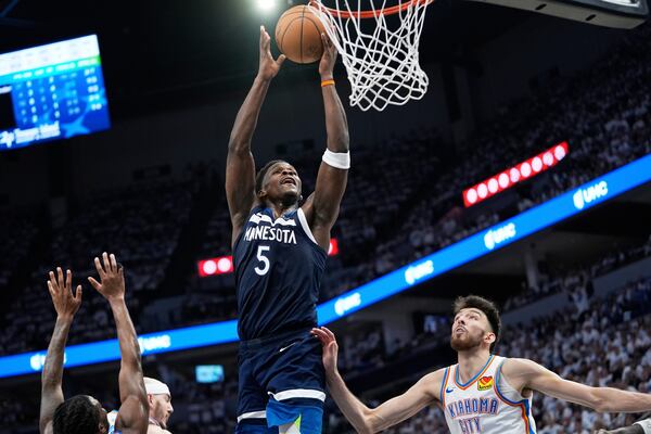 Minnesota Timberwolves guard Anthony Edwards (5) shoots against Oklahoma City Thunder forward Chet Holmgren, bottom right, during the second half of Game 4 of the Western Conference finals of the NBA basketball playoffs Monday, May 26, 2025, in Minneapolis. (AP Photo/Abbie Parr)
