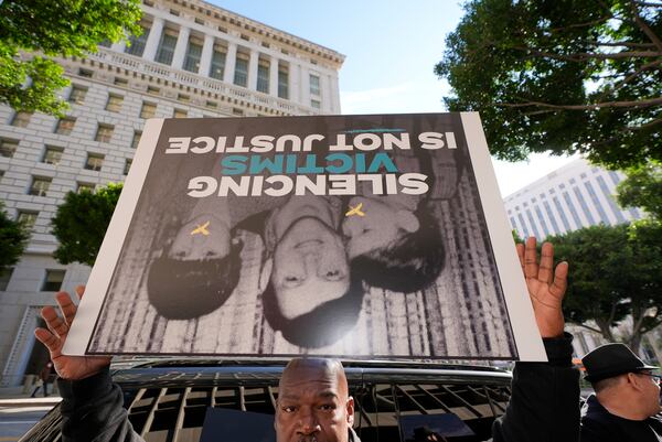 A supporter holds a sign during a press conference regarding developments in the Menendez brothers case Thursday, March 20, 2025, in Los Angeles. (AP Photo/Damian Dovarganes)