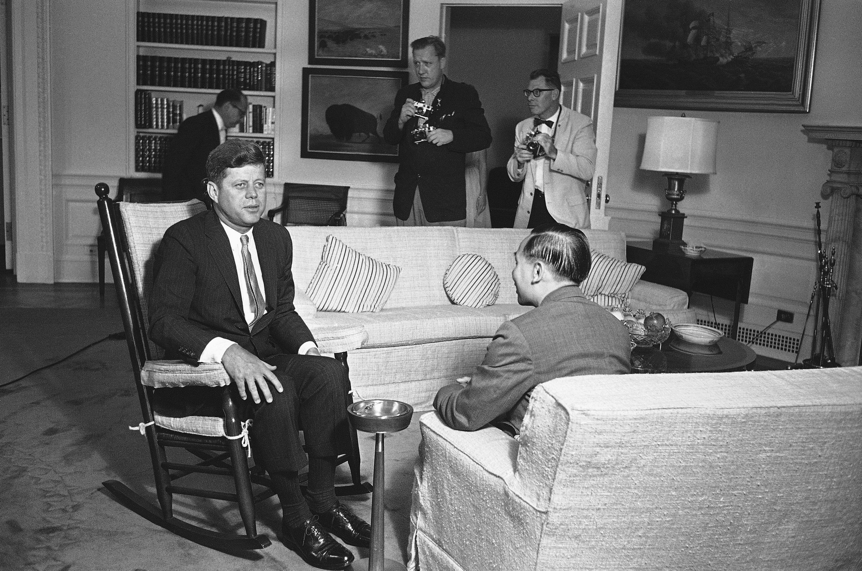 FILE - President Kennedy sits in his now famous rocking chair while talking with Nguyen Dinh Thuan, a top South Viet Nam official, at the White House in Washington on June 14, 1961. (AP Photo/Henry Burroughs, File)