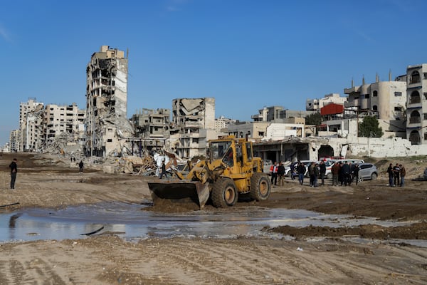 A bulldozer works to open the al Rashid main road for Palestinians who are returning from the southern parts of the Gaza Strip to the north, in Gaza City, Saturday, Jan. 25, 2025, days after the ceasefire deal between Israel and Hamas came into effect. (AP Photo/Abed Hajjar)