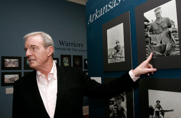 FILE - Former Arkansas Gov. Jim Guy Tucker talks about photographs on display made while serving as a U.S. Marine Corps war correspondent in 1965 and 1967, at the MacArthur Museum of Arkansas Military History in Little Rock, Ark., in Vietnam, March 4, 2010. (AP Photo/Danny Johnston, File)