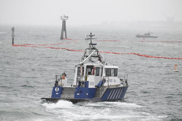 A San Diego Harbor patrol boat works along the shore near Shelter Island after a U.S. Navy plane crashed into the San Diego Bay, Wednesday, Feb. 12, 2025, in San Diego. (AP Photo/Denis Poroy)