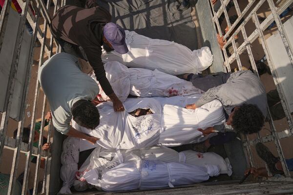 Palestinians load bodies of their relatives killed in the Israeli army airstrikes in Jabalia, northern Gaza Strip, on Wednesday, May 14, 2025. According to local hospitals, 48 people were killed in the strikes, including 22 children. (AP Photo/Jehad Alshrafi)