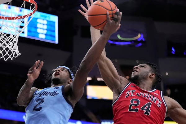 St. John's's Zuby Ejiofor fouls Marquette's Chase Ross during the first half of an NCAA college basketball game Saturday, March 8, 2025, in Milwaukee. (AP Photo/Morry Gash)