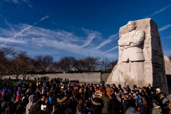 FILE - People attend a wreath-laying ceremony at the Martin Luther King Jr. Memorial marking MLK Day in Washington, Jan. 16, 2023. (AP Photo/Andrew Harnik, File)