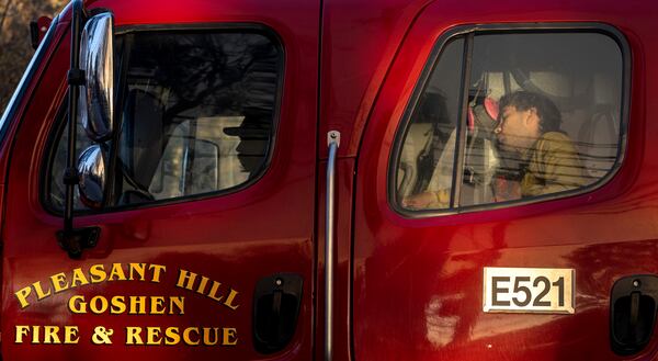 After a 24-hour shift battling blazes in the Pacific Palisades, firefighters from Pleasant Hills, Ore., rest in their vehicle Saturday, Jan. 11, 2025, in Los Angeles. (Mindy Schauer/The Orange County Register via AP)